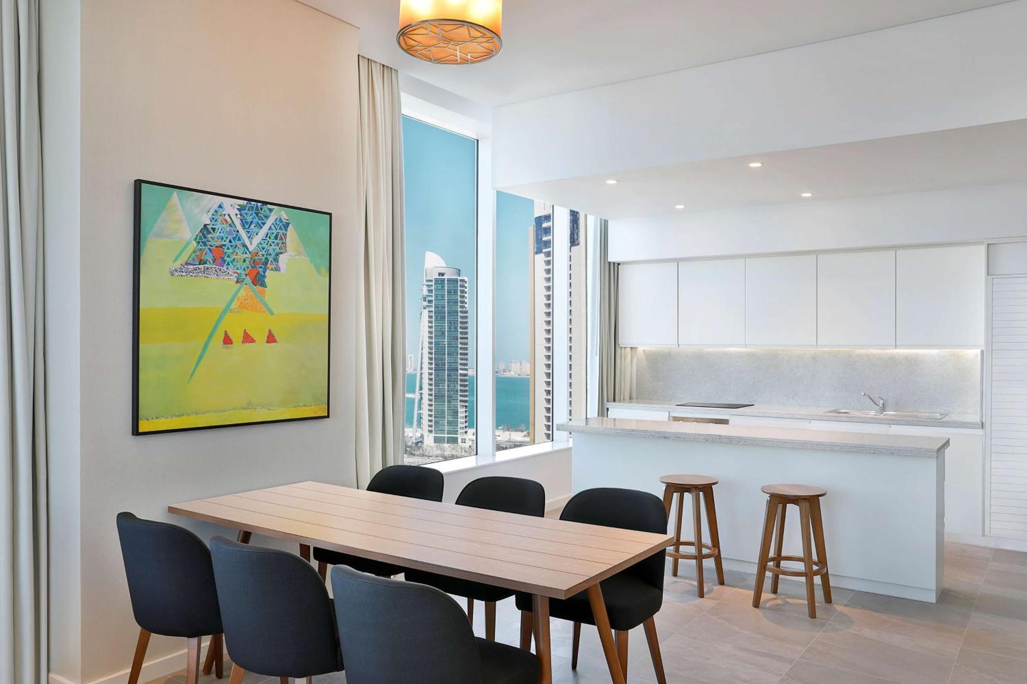 Aleph Doha Residences, Curio Collection By Hilton Exterior foto The kitchen and dining area of a typical apartment